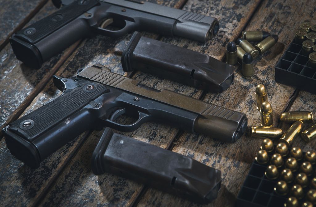 handguns on table with two mags and bullets